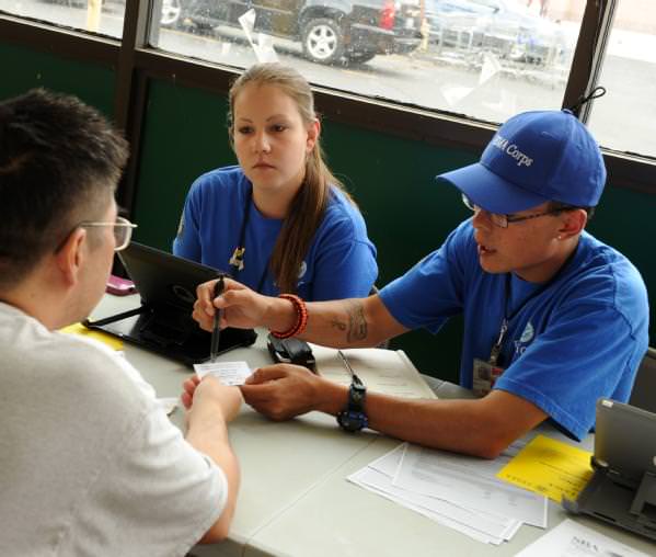FEMA Corps members register a local resident at a Vietnamese Survivor Event.